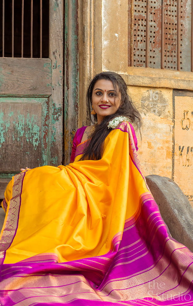 Mustard yellow kanchipuram silk saree with small korvai purple border