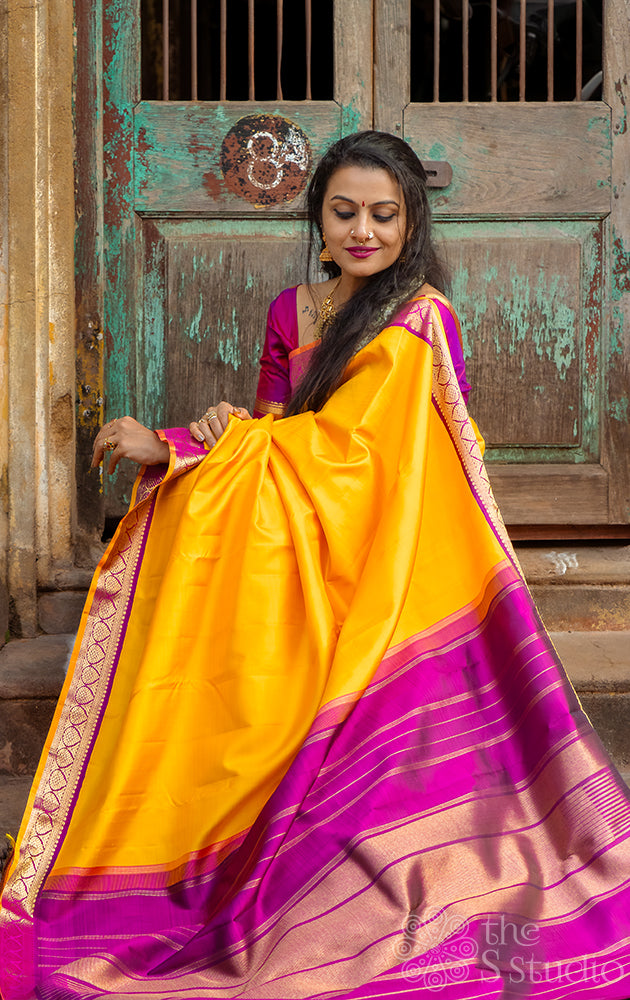 Mustard yellow kanchipuram silk saree with small korvai purple border