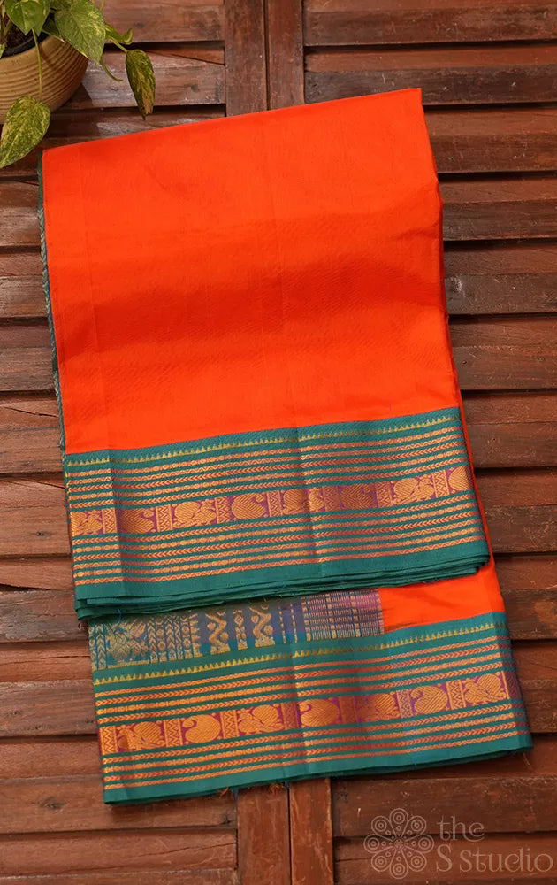 Bright orange silk cotton saree with sea blue korvai border