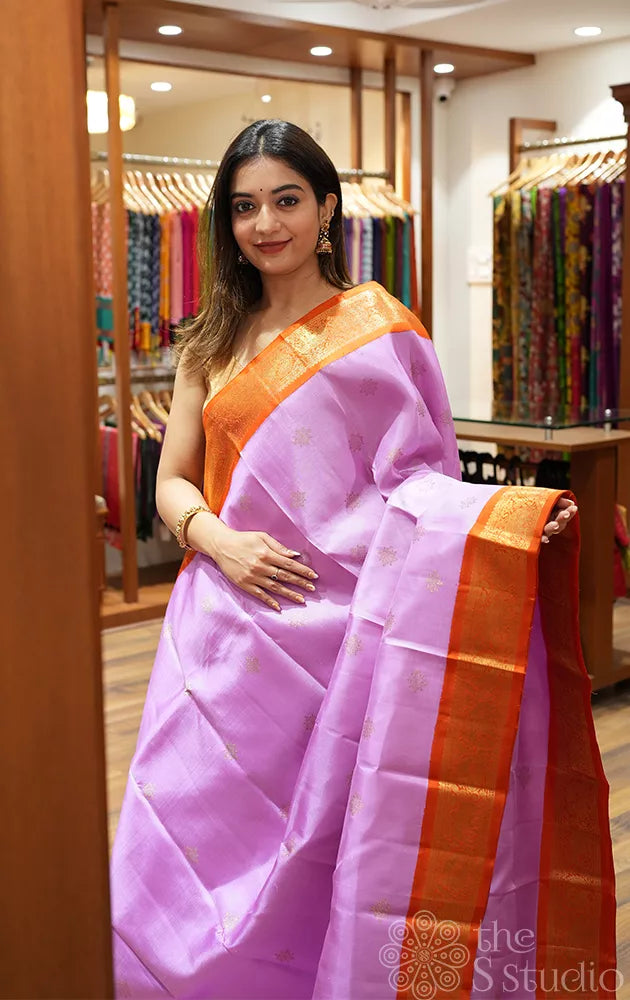 Lavender colour kanjivaram silk saree with a korvai orange border