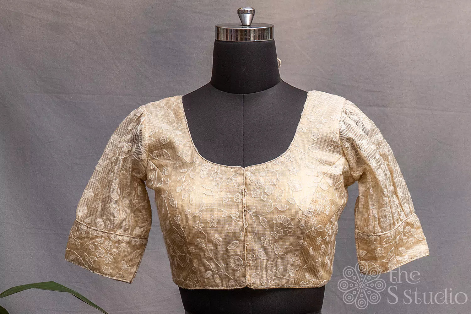 Cream colour ready made blouse with floral self embroidery