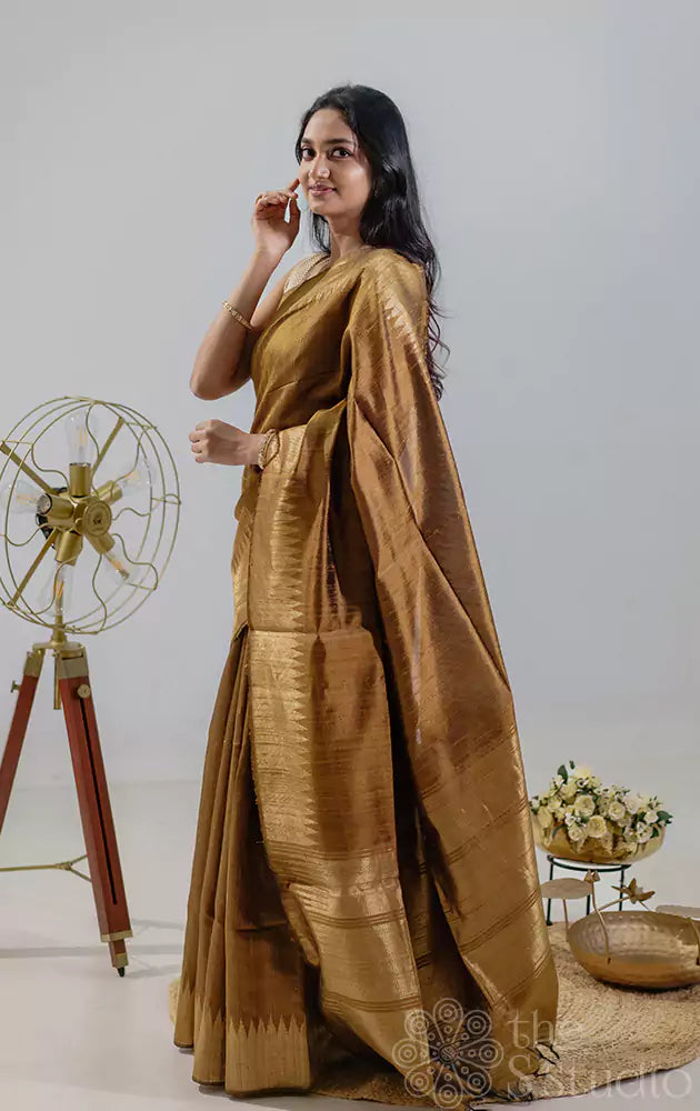 Golden mustard handwoven raw silk saree featuring a temple zari border.