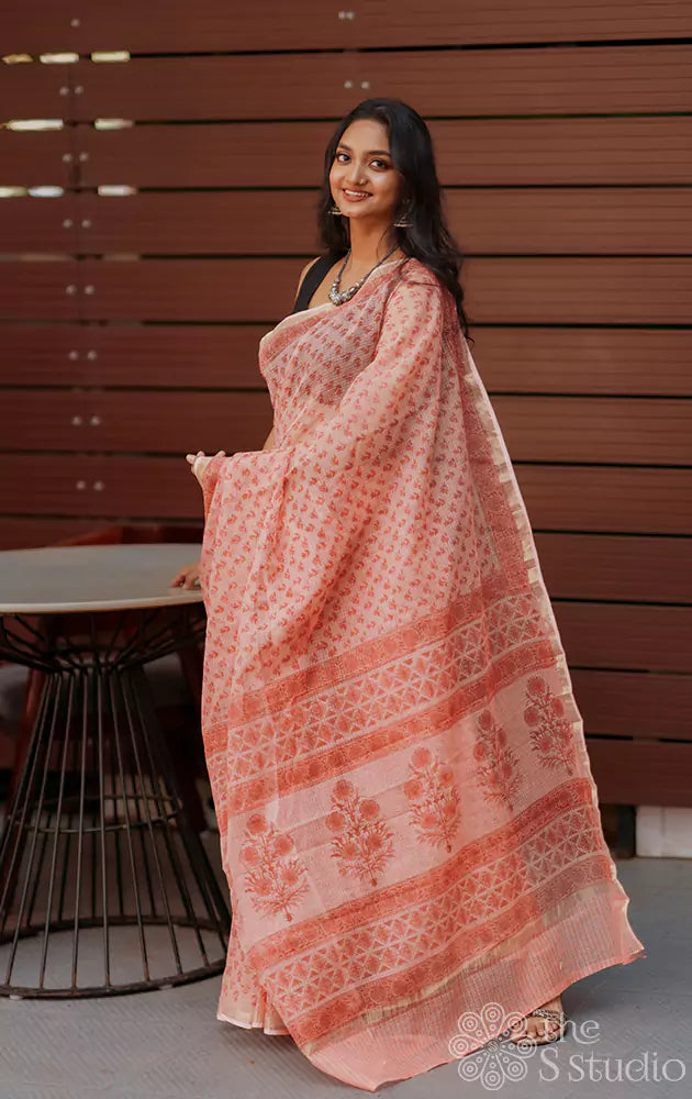 Peach kota cotton saree with floral print and zari border
