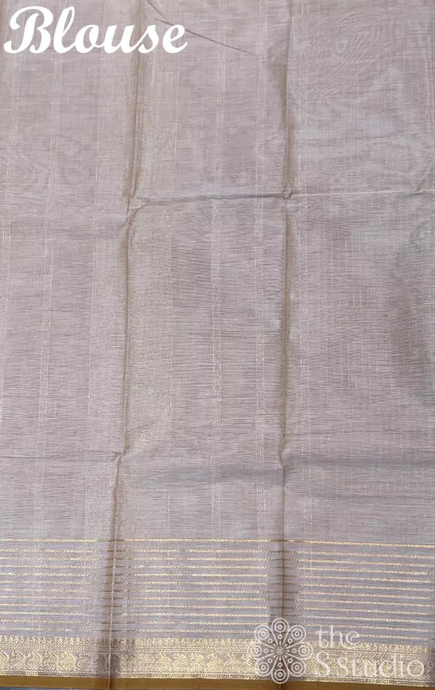 Beige kanchi cotton saree with zari lines along the border