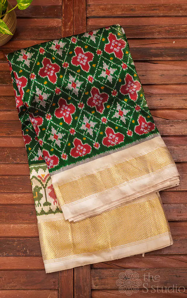 Dark green ikkat silk saree with offwhite border