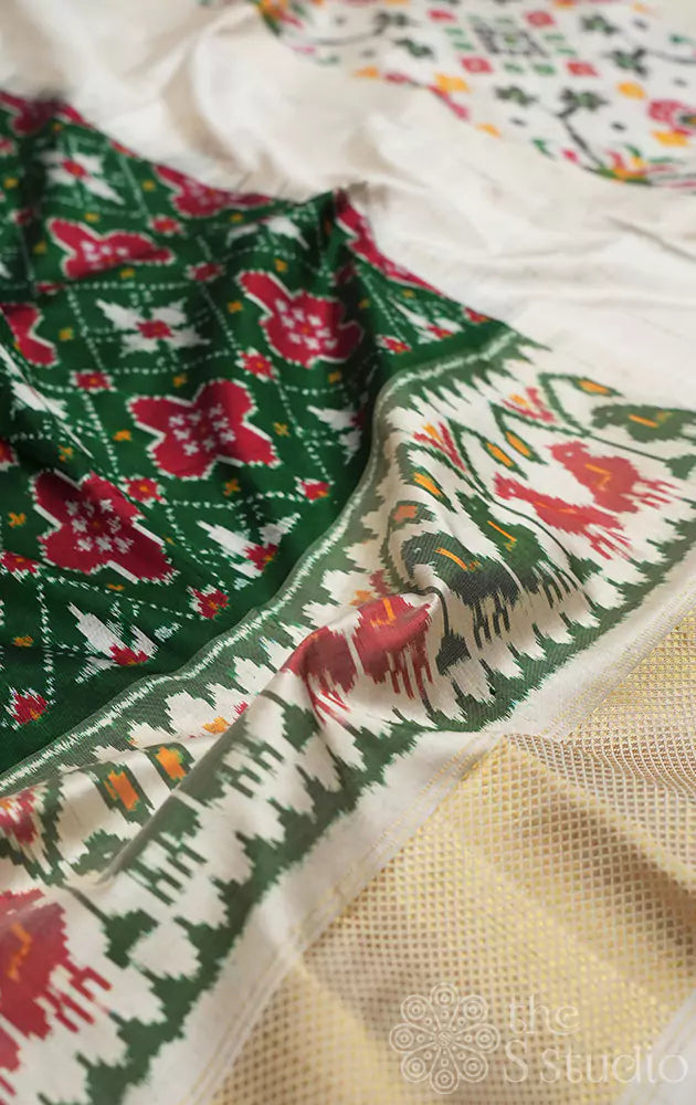 Dark green ikkat silk saree with offwhite border