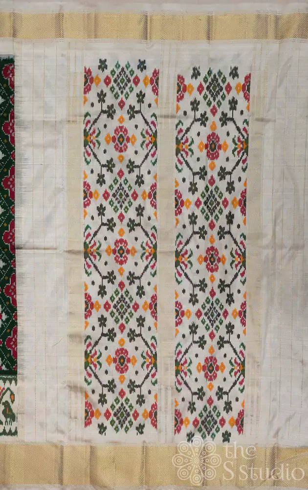 Dark green ikkat silk saree with offwhite border