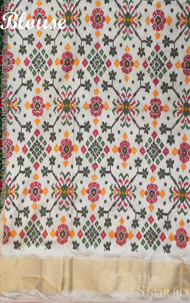 Dark green ikkat silk saree with offwhite border