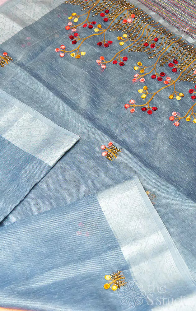Grey linen tissue silk saree with floral embroidery