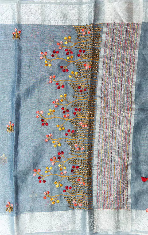 Grey linen tissue silk saree with floral embroidery