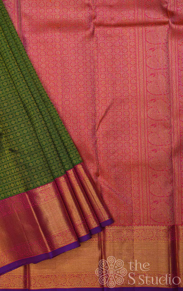 Green kanjivaram silk saree with peachish pink korvai border