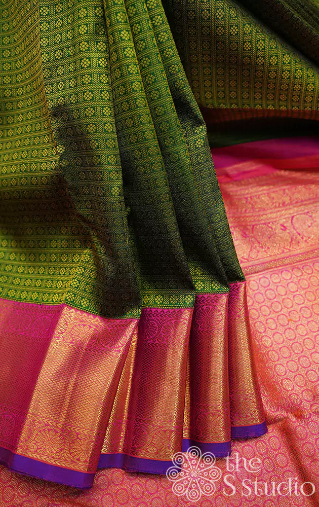 Green kanjivaram silk saree with peachish pink korvai border