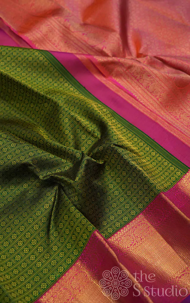 Green kanjivaram silk saree with peachish pink korvai border