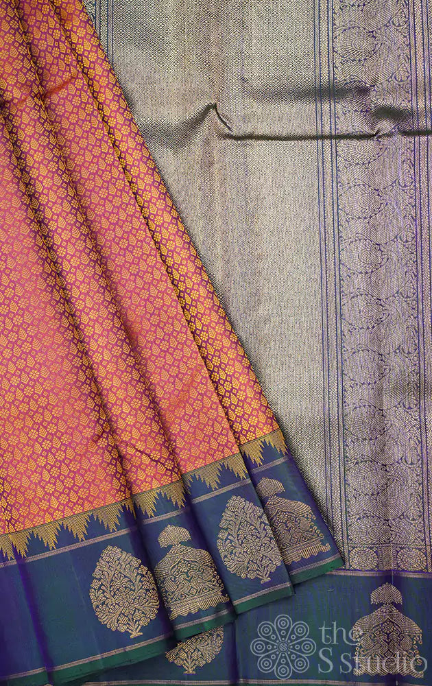 Peachish orange kanjivaram silk saree with a peacock blue border