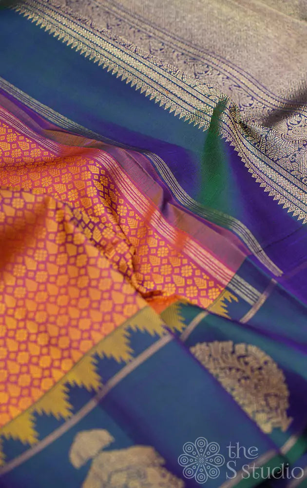 Peachish orange kanjivaram silk saree with a peacock blue border