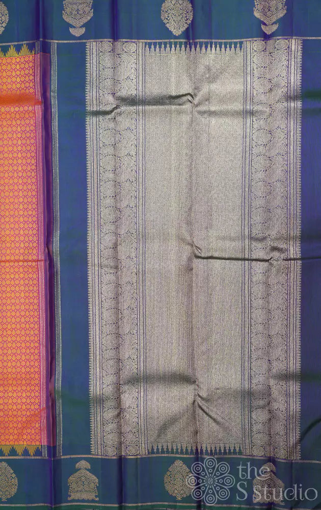 Peachish orange kanjivaram silk saree with a peacock blue border