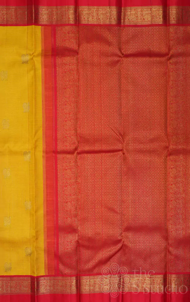 Mango yellow kanchi silk saree with bright red korvai border