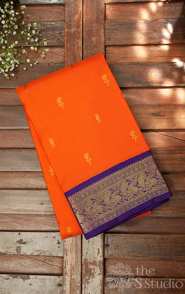 Orange kanchipuram silk saree with Navy Blue korvai border