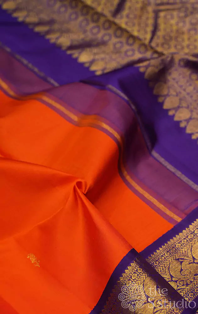 Orange kanchipuram silk saree with Navy Blue korvai border