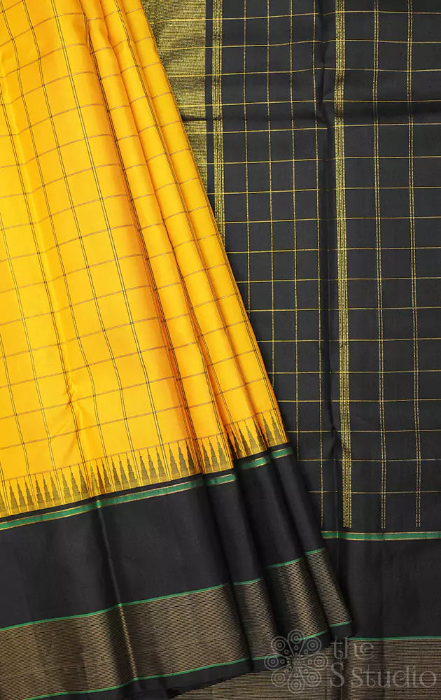 Mustard yellow checked kanchipuram silk saree with black border