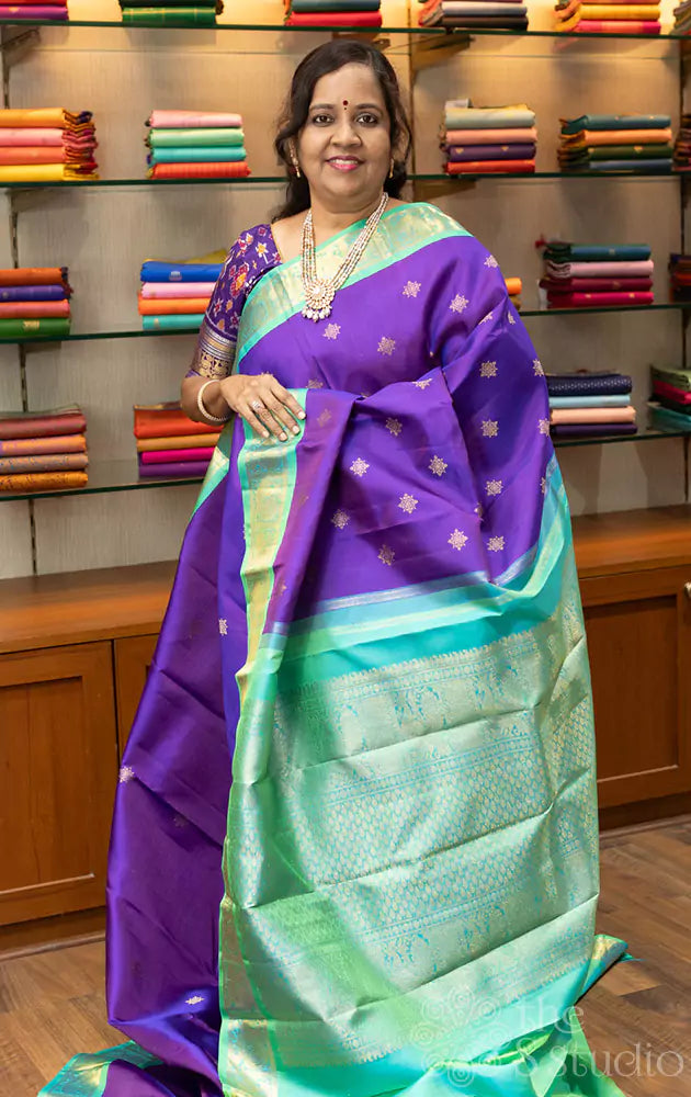 Violet Kanchipuram silk saree with sea green korvai border