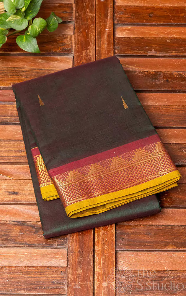 Bottle green handwoven kanchi cotton saree with maroon border and grand pallu with creative shot