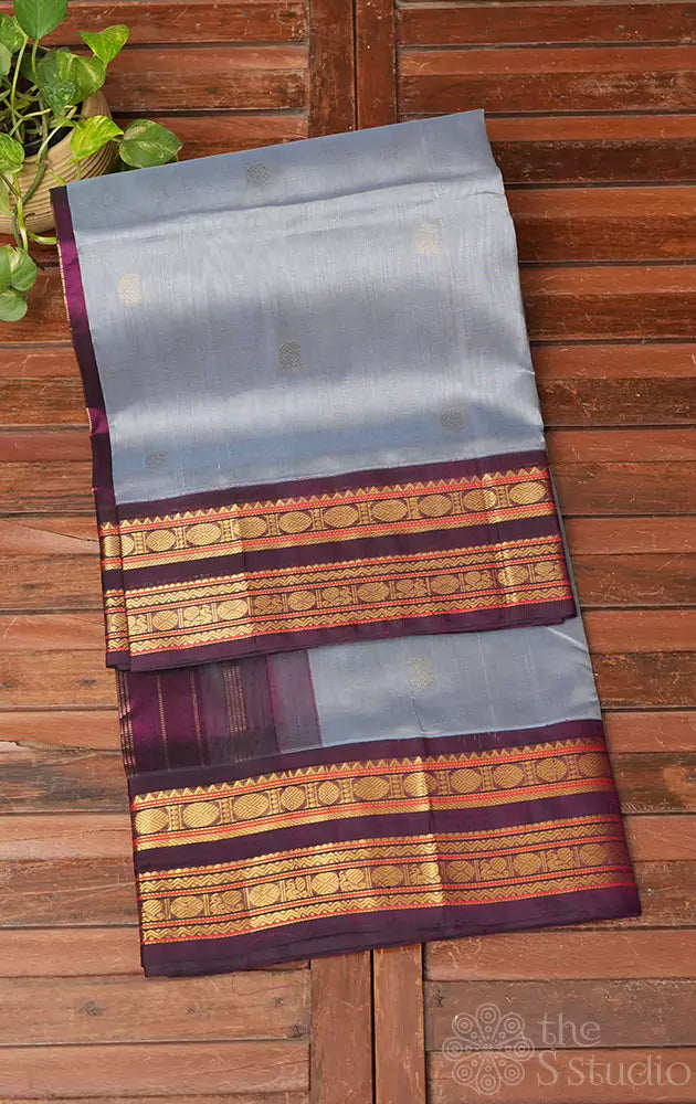 Grey silk cotton saree with purple korvai border