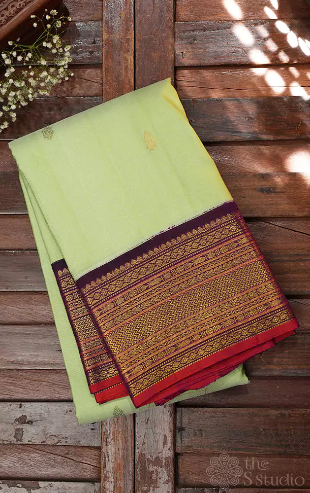 Pista green kanchi pattu saree with korvai purple border