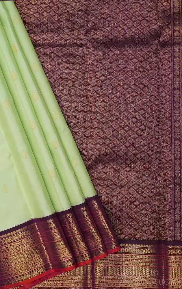 Pista green kanchi pattu saree with korvai purple border