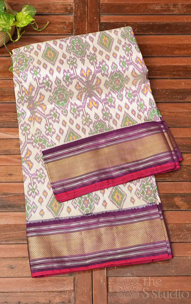 Off white and purple ikkat silk saree with zari border