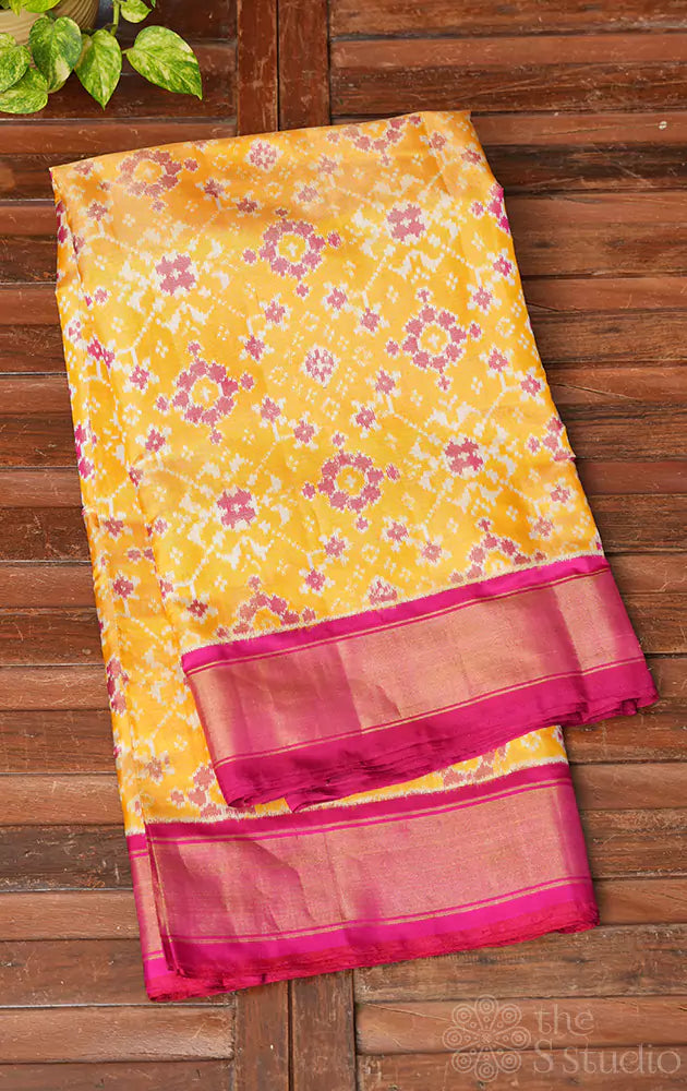 Yellow tissue ikkat silk saree with rani pink border