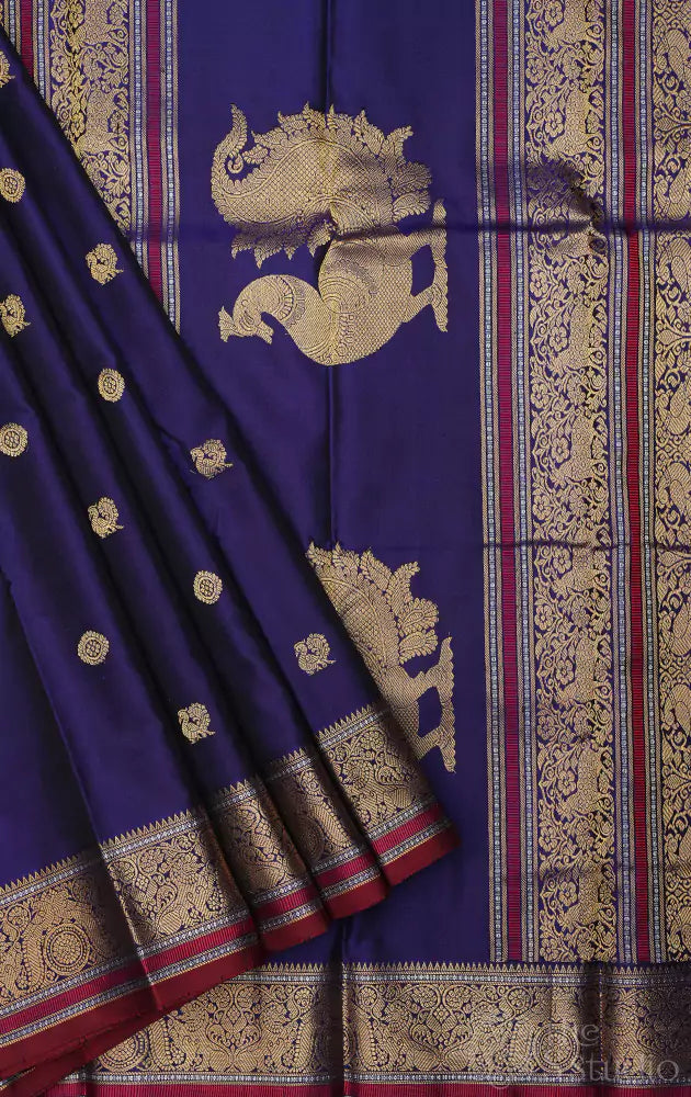 Violet kanchi silk saree with mayil chakaram buttas