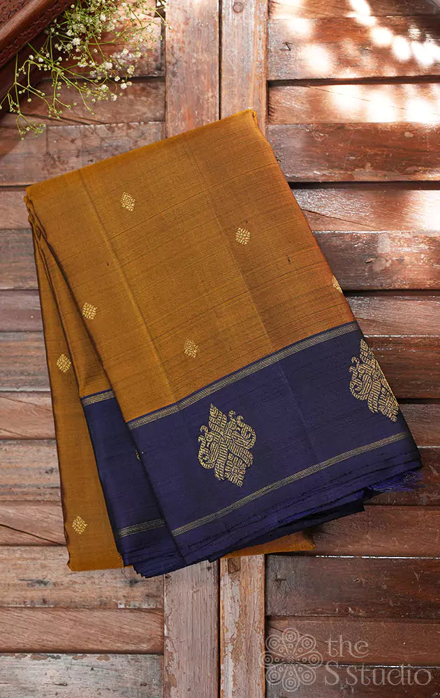 Golden brown kanjivaram silk saree with peacock buttas border