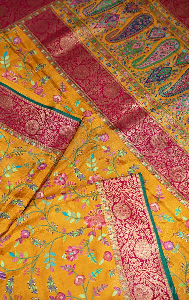 Mustard semi crepe banarasi silk saree with floral and bird embroidery
