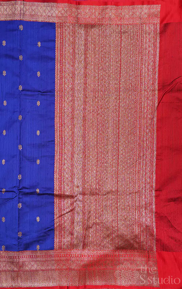 Blue raw silk saree with small zari buttas and contrast red border