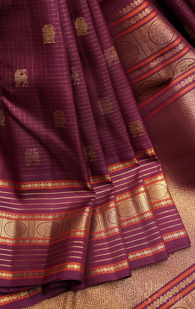Brown zari checked kanchipuram silk saree with yazhi and peacock motifs