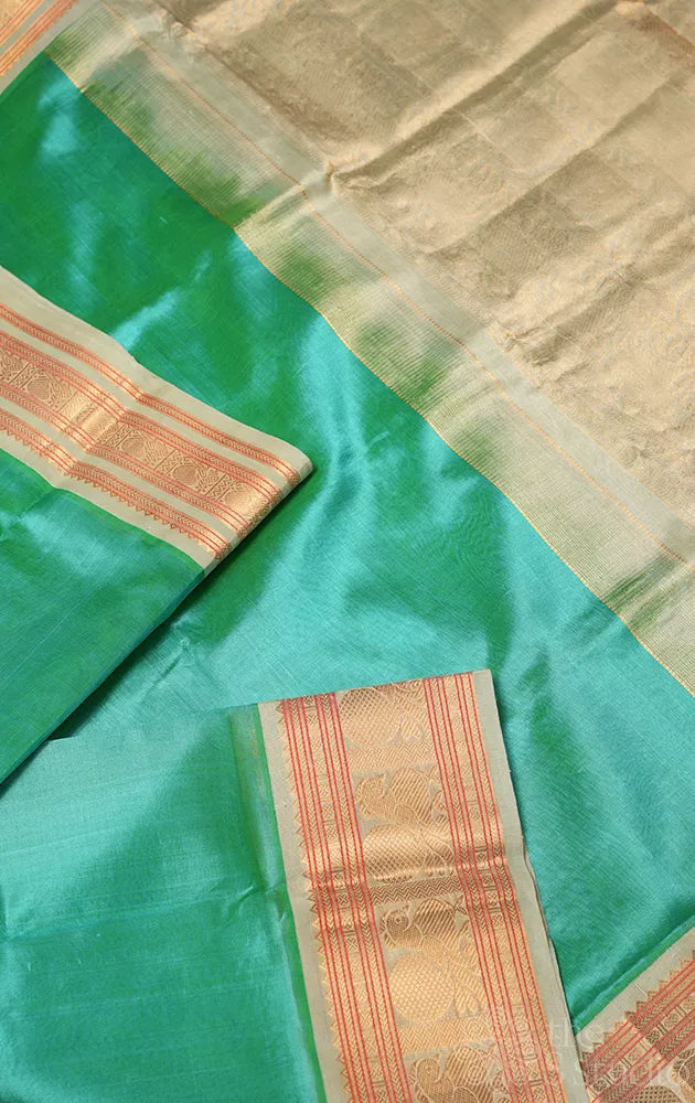 Sea green plain silk cotton saree with korvai border