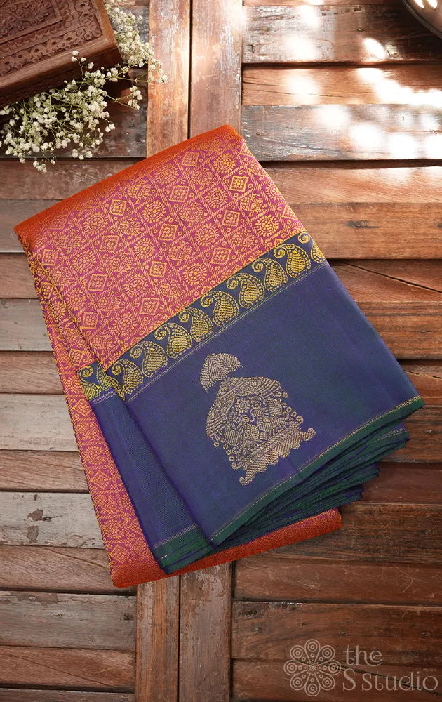 Peachish orange kanjivaram silk saree with a peacock blue border