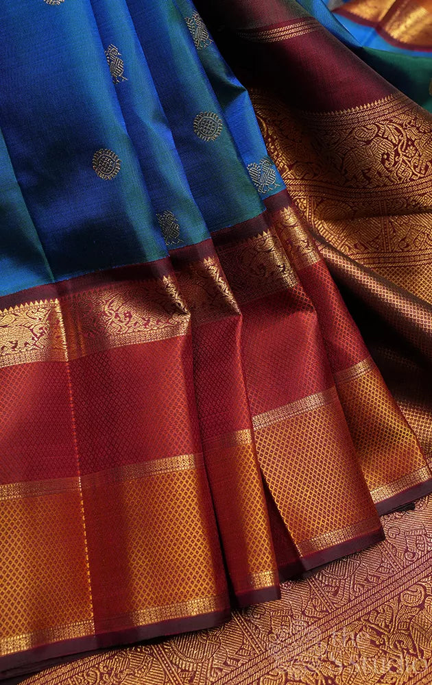Peacock blue kanchipuram silk saree with maroon korvai border