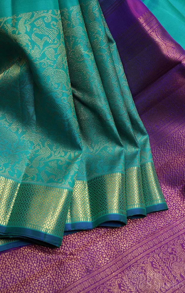 Bluish green kanchi silk saree with vanasingharam design and getti border