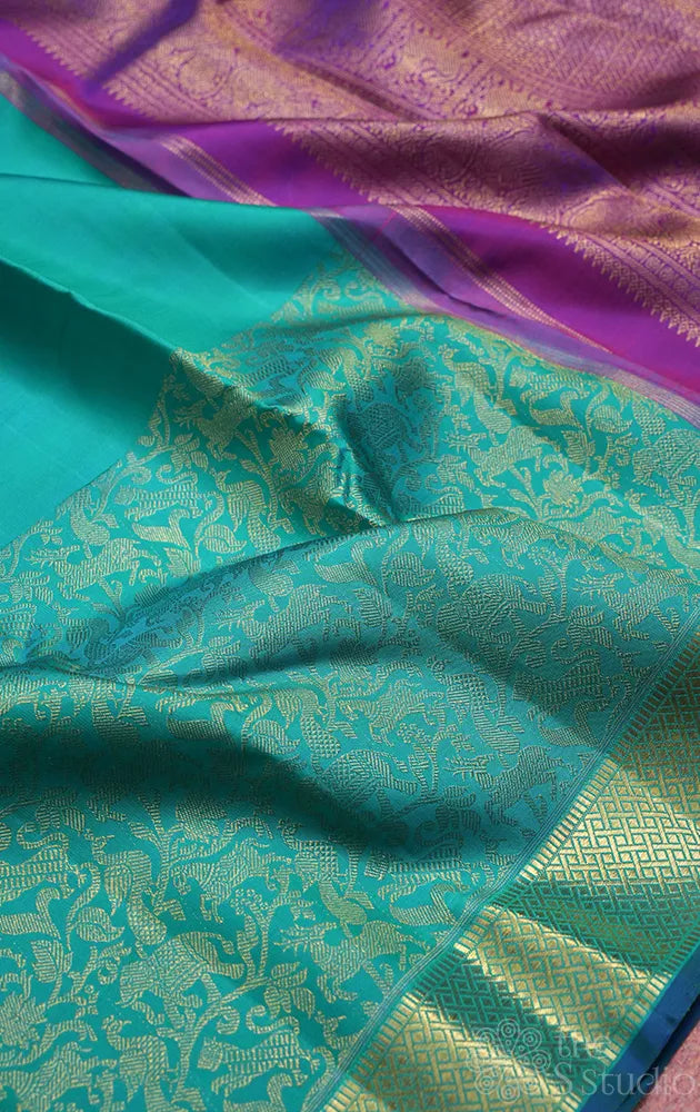 Bluish green kanchi silk saree with vanasingharam design and getti border