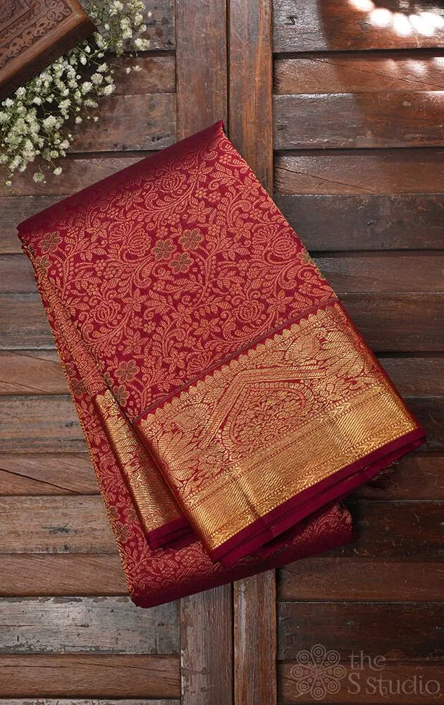 Maroon kanjivaram silk saree with all over floral meenakari motifs and grand border