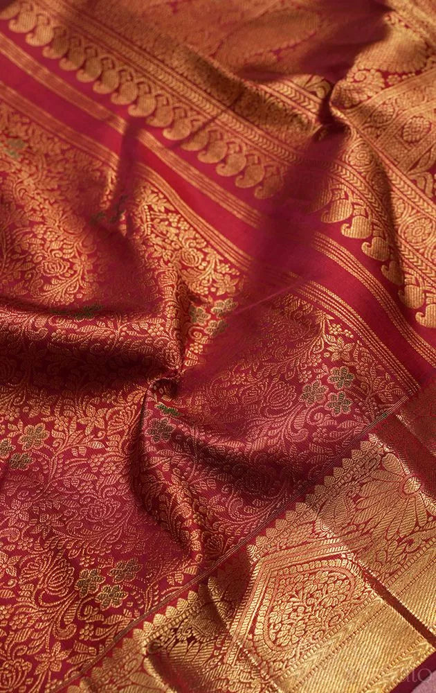 Maroon kanjivaram silk saree with all over floral meenakari motifs and grand border