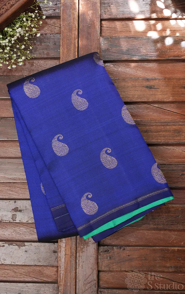 Royal blue kanchi pattu saree with paisley motifs and sea green pallu