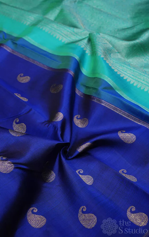 Royal blue kanchi pattu saree with paisley motifs and sea green pallu