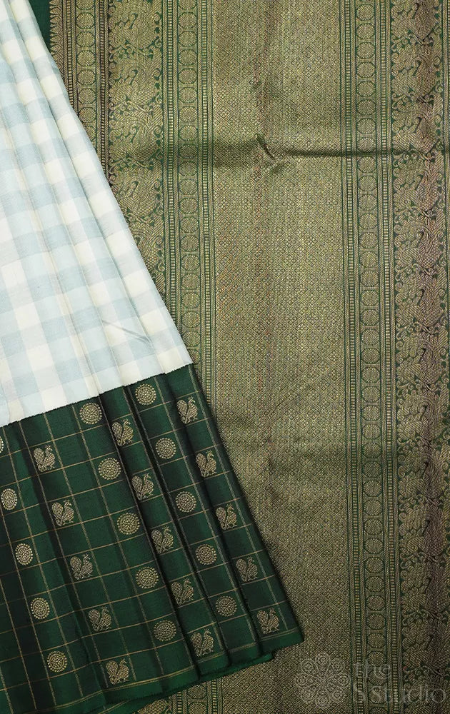White and pastel green checked kanchi silk saree with bottle green long border
