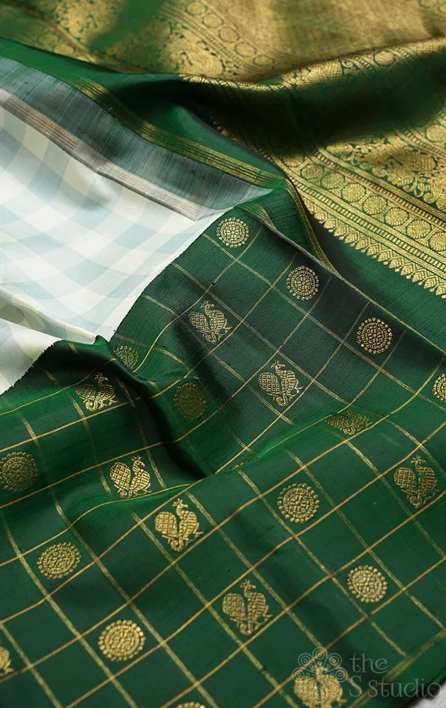 White and pastel green checked kanchi silk saree with bottle green long border