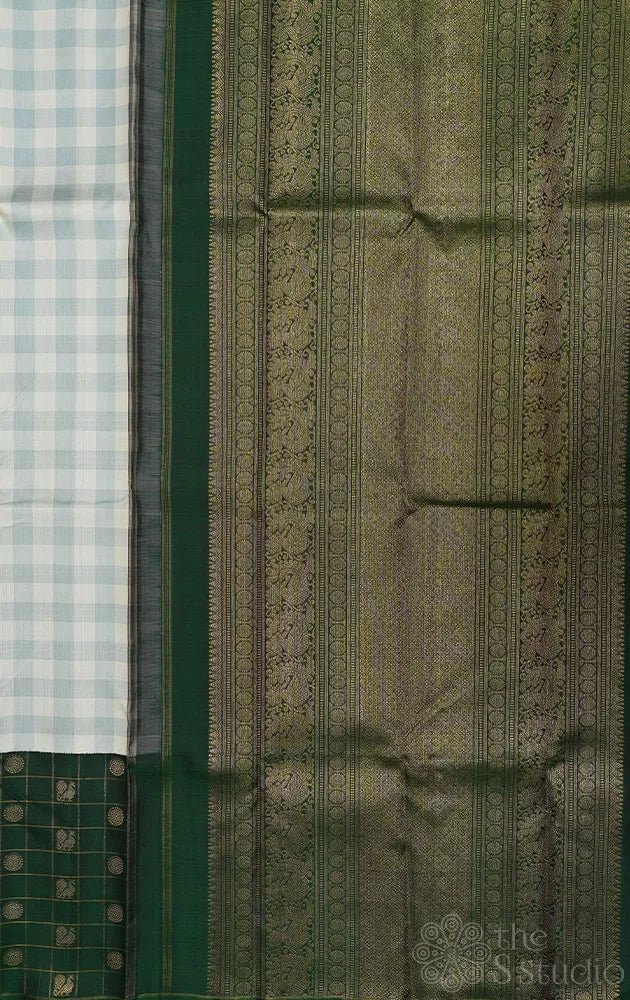 White and pastel green checked kanchi silk saree with bottle green long border
