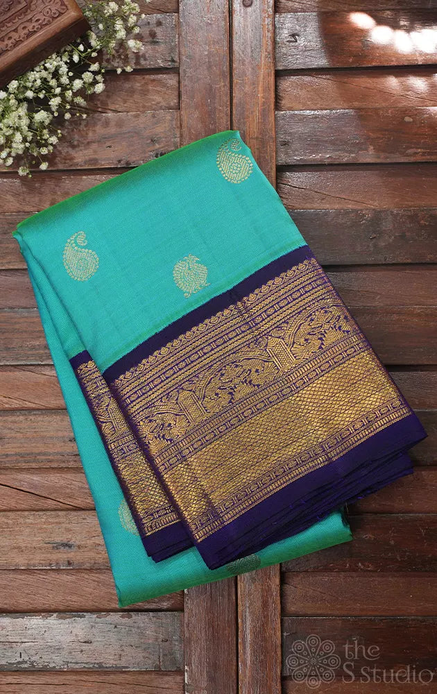 Sea green kanchi silk saree with korvai navy blue border