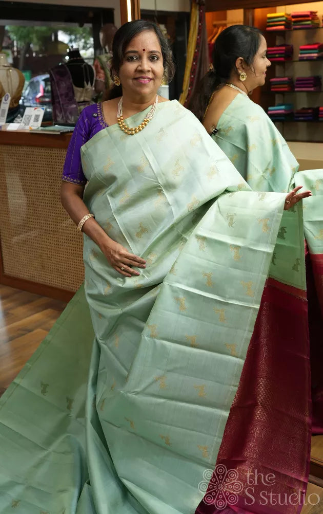 Elaichi green Kanjivaram silk saree with deer zari buttas and contrast pallu